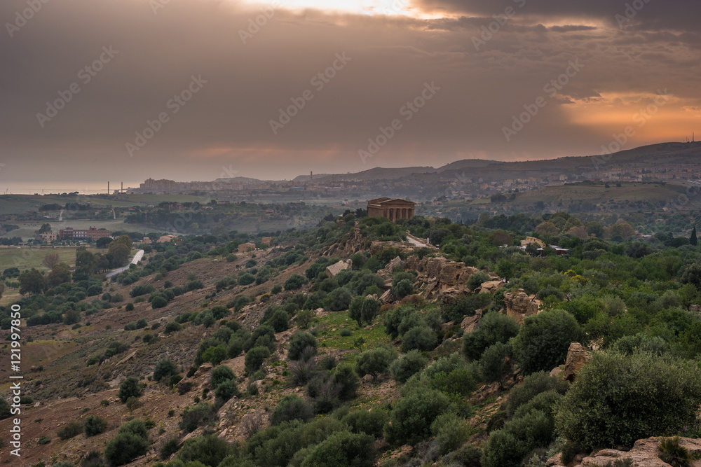 Sunset in Valley of temples in Agrigento in Sicily with clouds and night illumination. Sunset in Valley of temples in Agrigento in Sicily with clouds and night illumination.