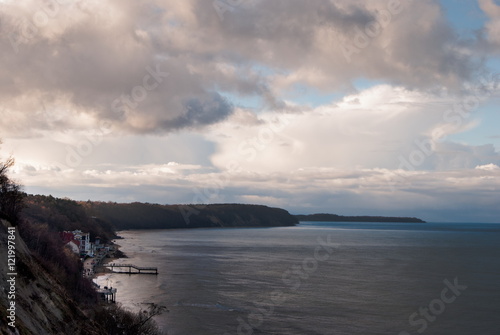 Beach in Svetlogorsk, Kaliningrad. Photo of beautiful panorama view of sea shore, forest and clouuds at sunset.