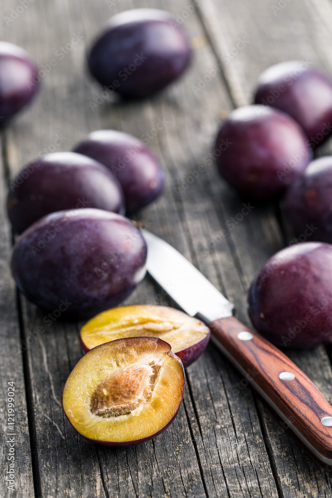 Fototapeta premium Halved ripe plums.