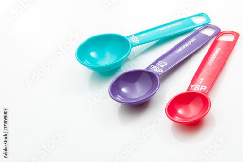 Photography Colorful Measuring spoons on a white background.