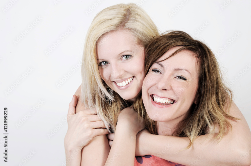Best friends are smiling into the camera. Isolated with light background. Best friends are smiling into the camera. Isolated with light background.