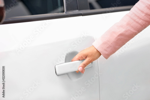 Female hand opening car door