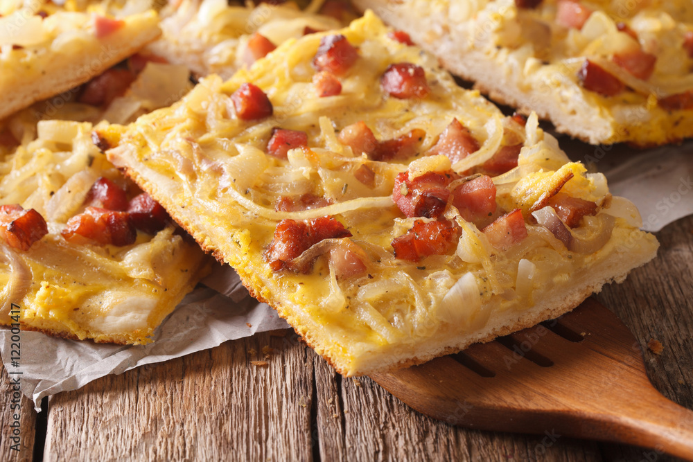 Traditional German pie with onion, bacon close-up. horizontal
