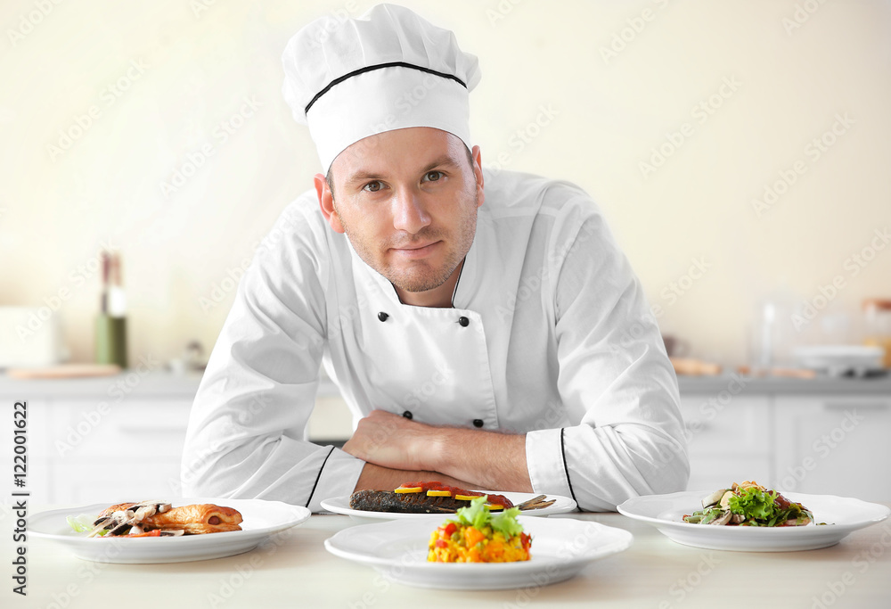 Young chef cook with different dishes in kitchen