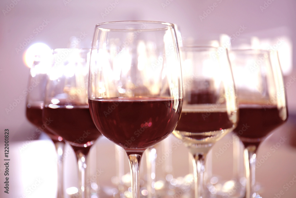Glasses with red and white wine on table in restaurant