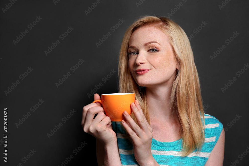 Beautiful girl with cup of coffee on grey background Beautiful girl with cup of coffee on grey background