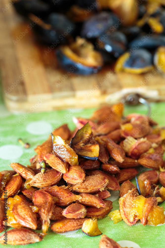 Plums sliced on a wooden board Plums sliced on a wooden board