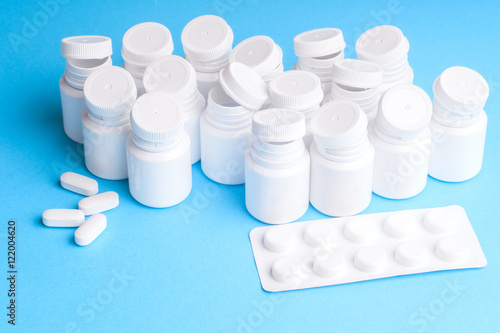 Many pills and tablets isolated on light blue background