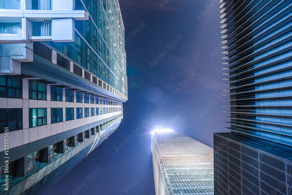 Modern Buildings Against Sky at night.