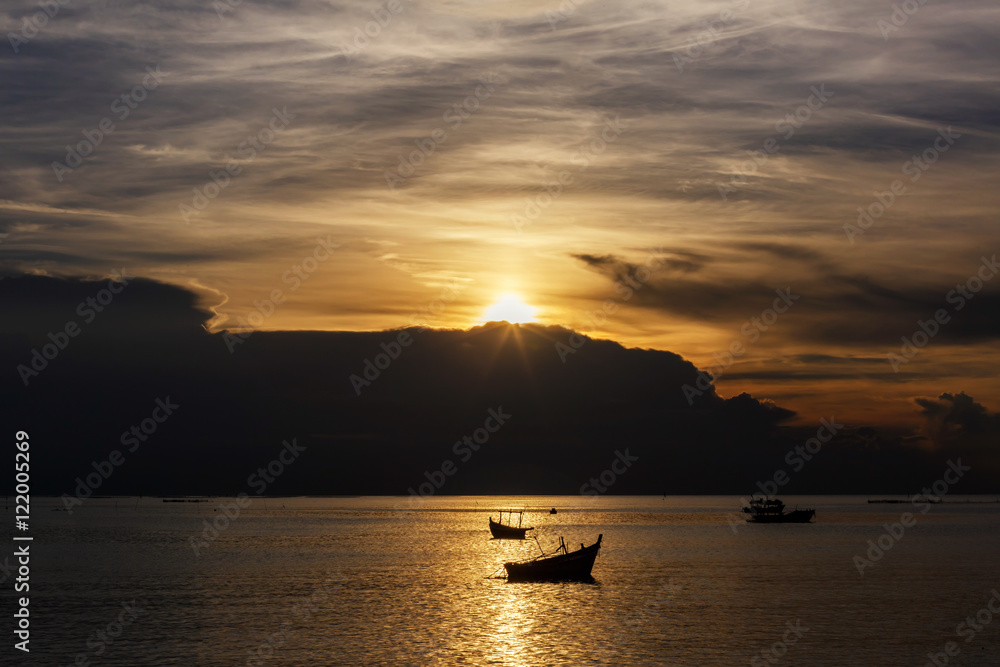 Silhouette boat with sunset as a background

