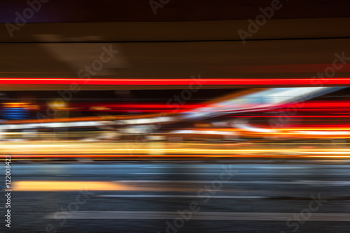 blurred traffic light trails on road at night in China.