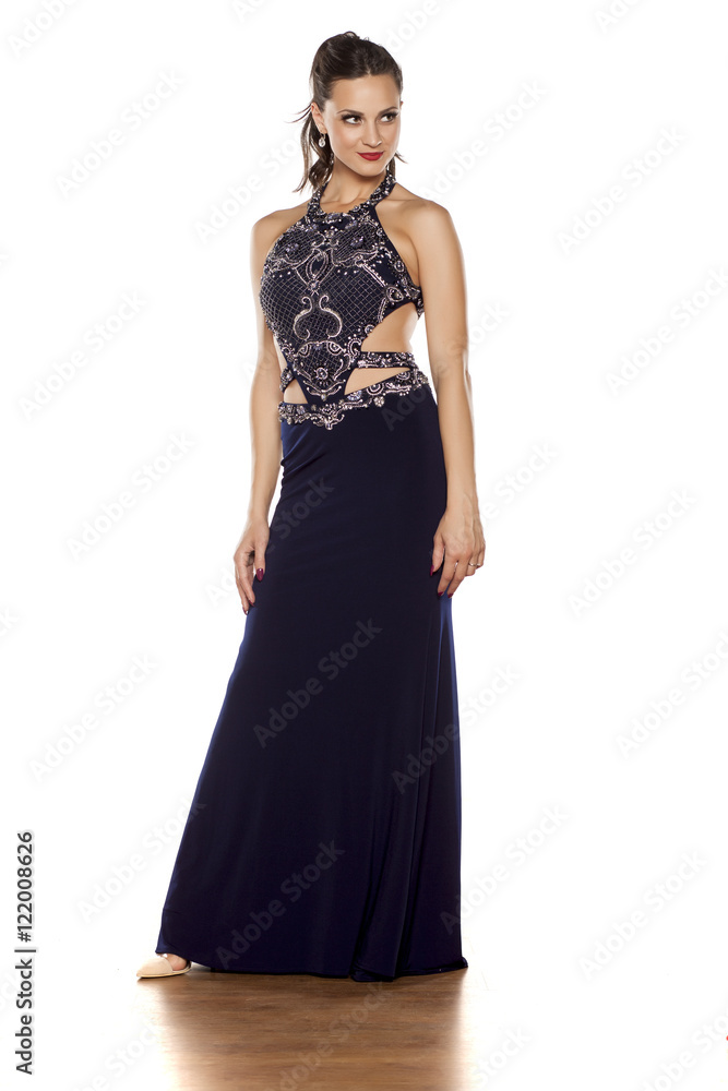 young beautiful woman posing in a long blue dress on a white background young beautiful woman posing in a long blue dress on a white background