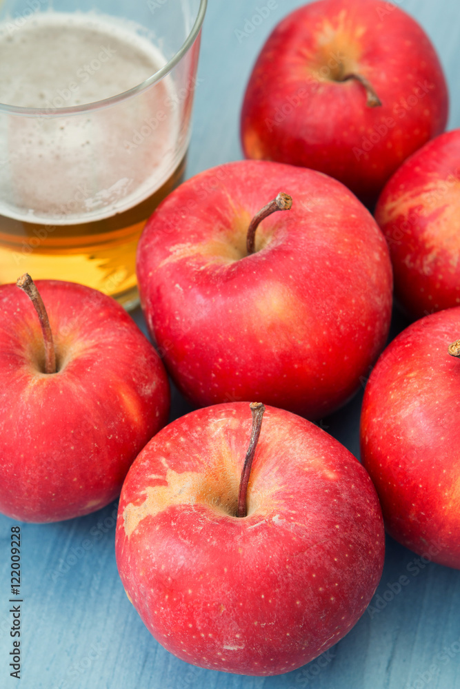 Ripe red apples with a glass of cider Ripe red apples with a glass of cider