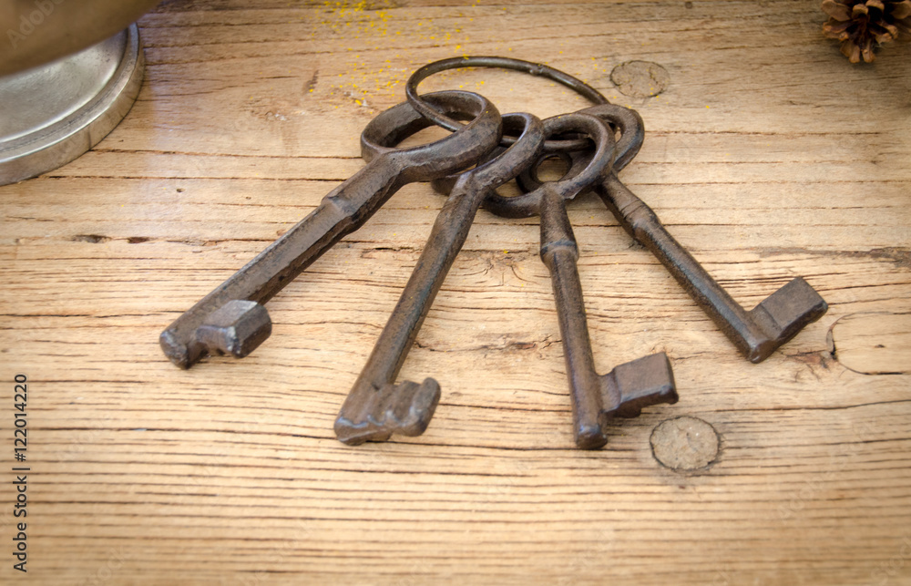Rusty antique keys on wooden table as background Rusty antique keys on wooden table as background