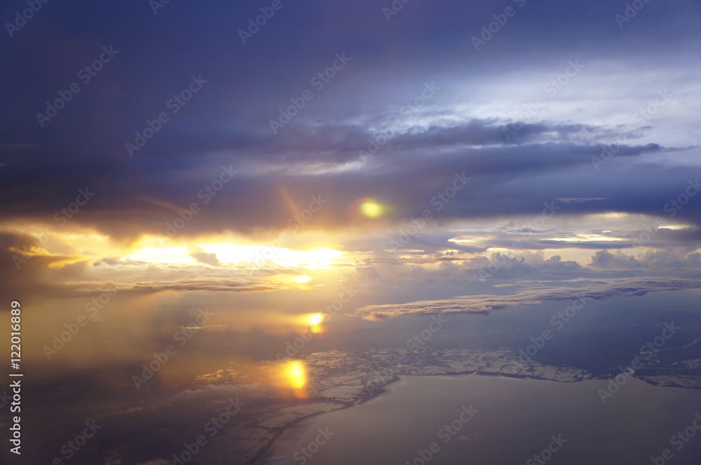 Golden light rays sunset rich in dark space clouds,over the ocean