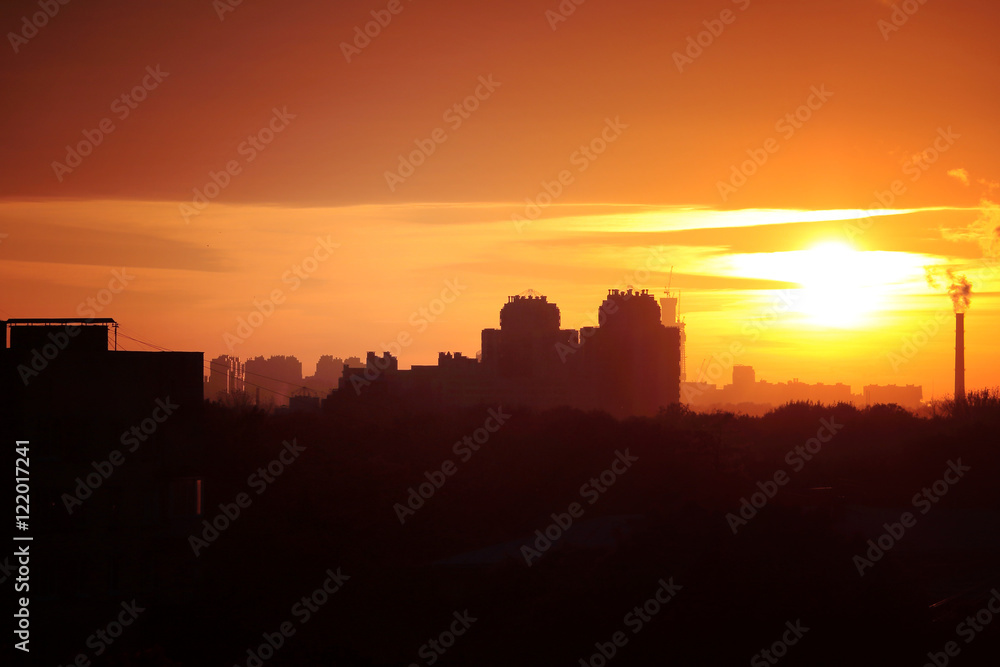 Beautiful evening cityscape. Aerial view. Skies, hazy sun, skyline, horizon. Selective focus. Special light.