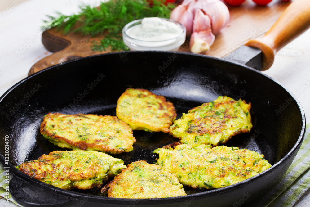 Zucchini Pancakes With  Sour Cream in Pan