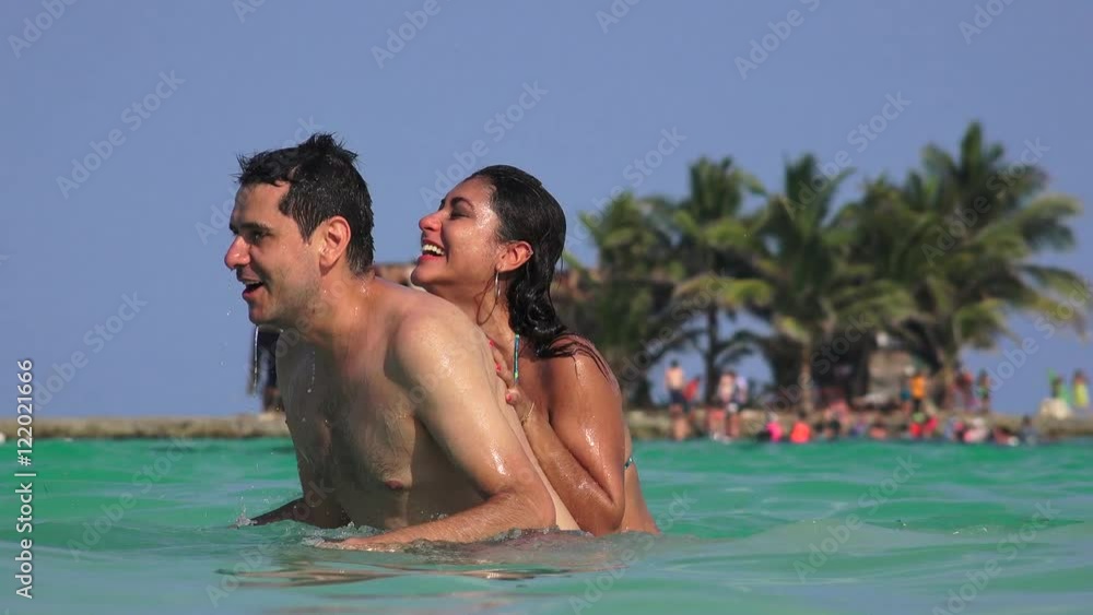 Man And Woman Having Fun Playing In Ocean Water On Summer Vacation Man And Woman Having Fun Playing In Ocean Water On Summer Vacation