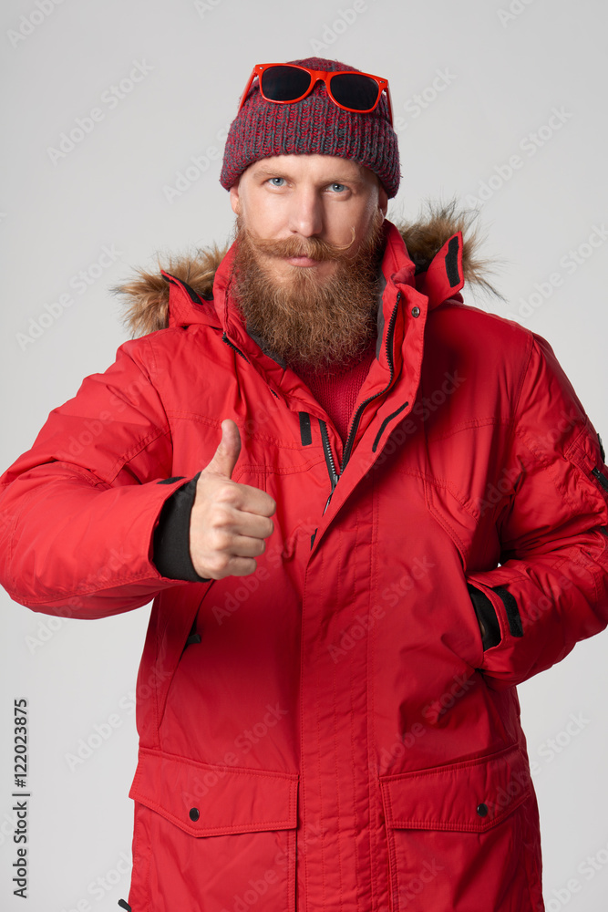 Serious bearded man showing thumb up Serious bearded man showing thumb up