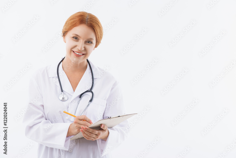 Joyful female physician working with pleasure Joyful female physician working with pleasure