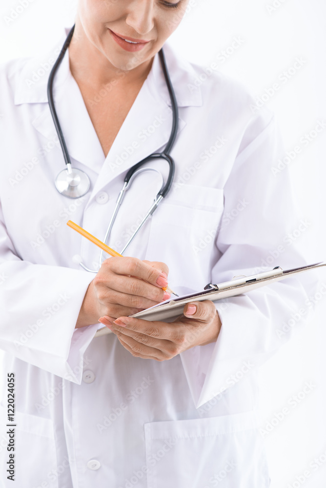 Experienced general practitioner making notes Experienced general practitioner making notes