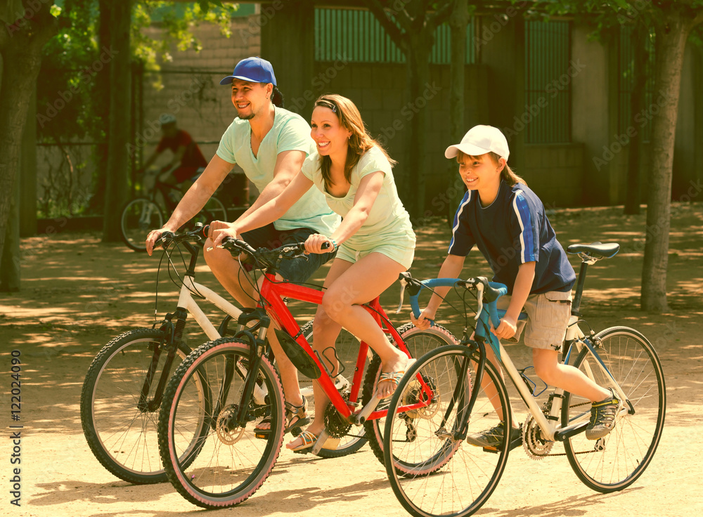 Fototapeta premium Couple with son on bicycles
