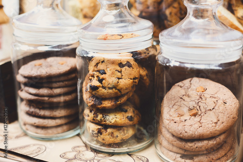 Stampa su tela Cookies and biscuits in glass jars on bar for sale