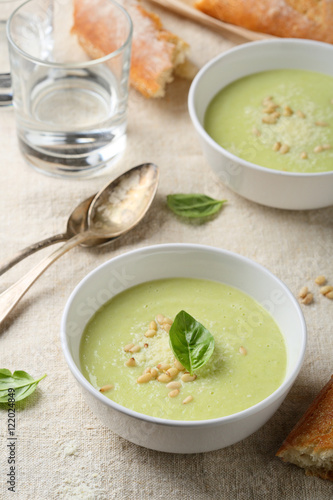Green puree soup in white bowl