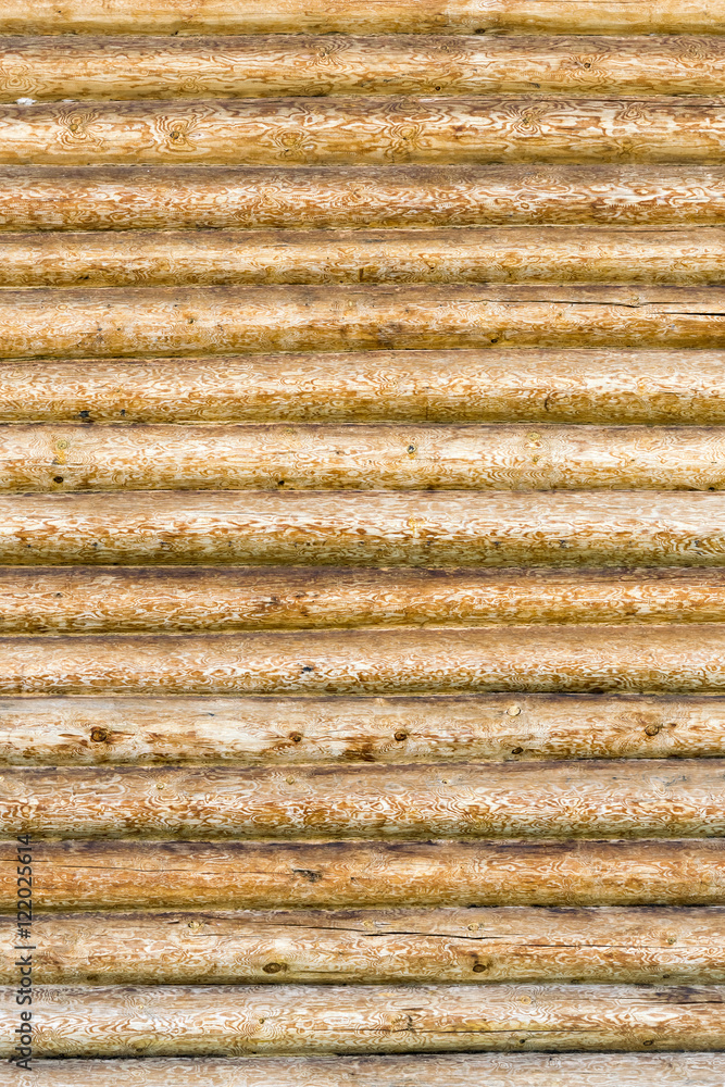 Roundish brown and yellow wooden logs, background Roundish brown and yellow wooden logs, background