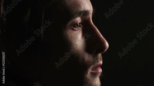 Man looking in dark room. profile