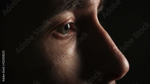 man looking in a dark room. Eyes closeup