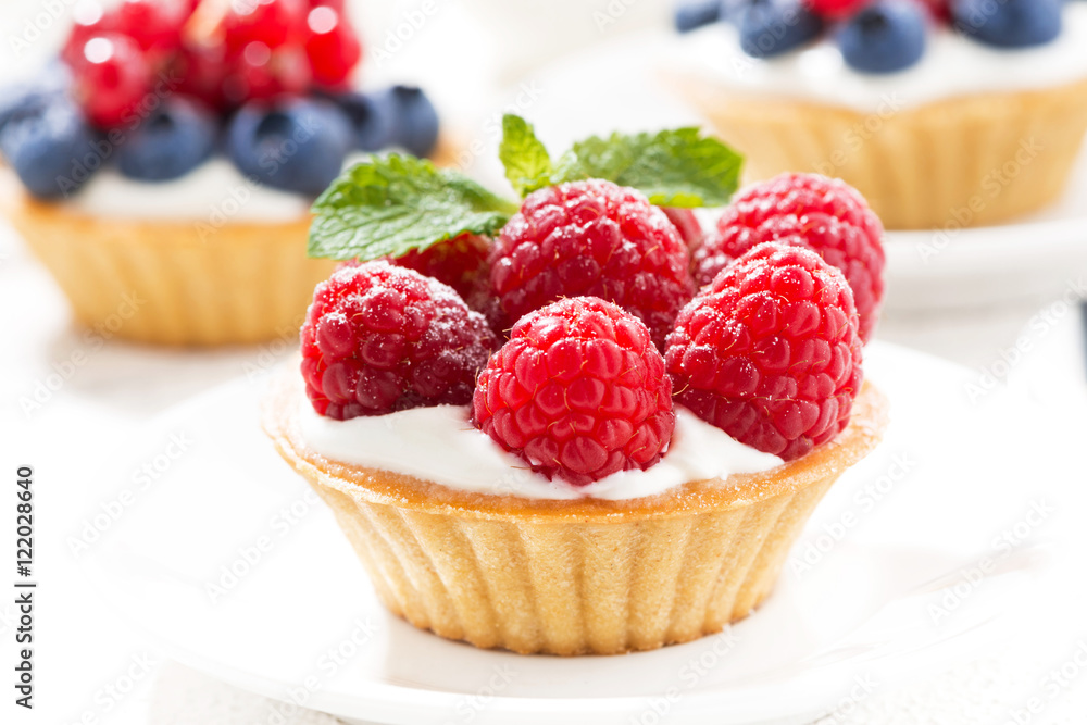 mini tarts with cream and berries, closeup mini tarts with cream and berries, closeup