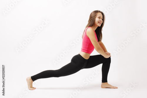 Girl doing workout on a white background studio