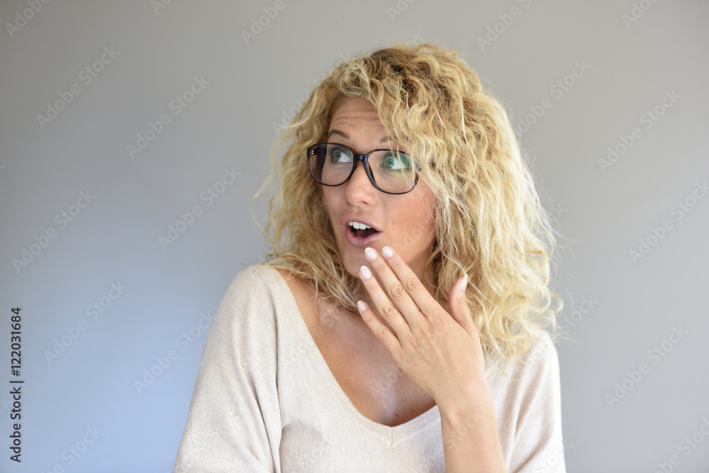 Portrait of blond woman with eyeglasses being expressive Portrait of blond woman with eyeglasses being expressive