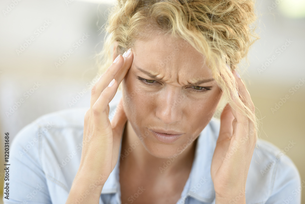 Middle-aged woman suffering headache Middle-aged woman suffering headache