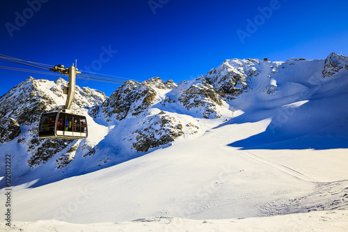 Winter landscape with cable car and lift station on the top of s