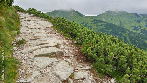 Rocky trail high in the mountains. Mountain peaks are hidden by clouds. Kasprowy Wierch, Tatra Mountains, Poland.
