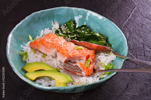 Salmon with spinach and avocado. Rice as a garnish