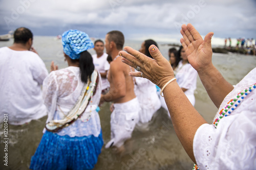 Worshippers clapping in motion blur at the Festival of Yemanja in Salvador, Bahia, Brazil  photo