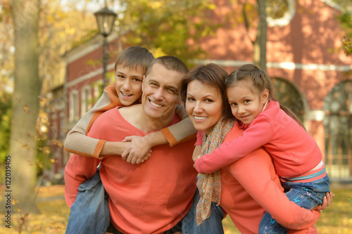 Family relaxing in autumn park