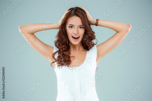 The happy woman on gray background