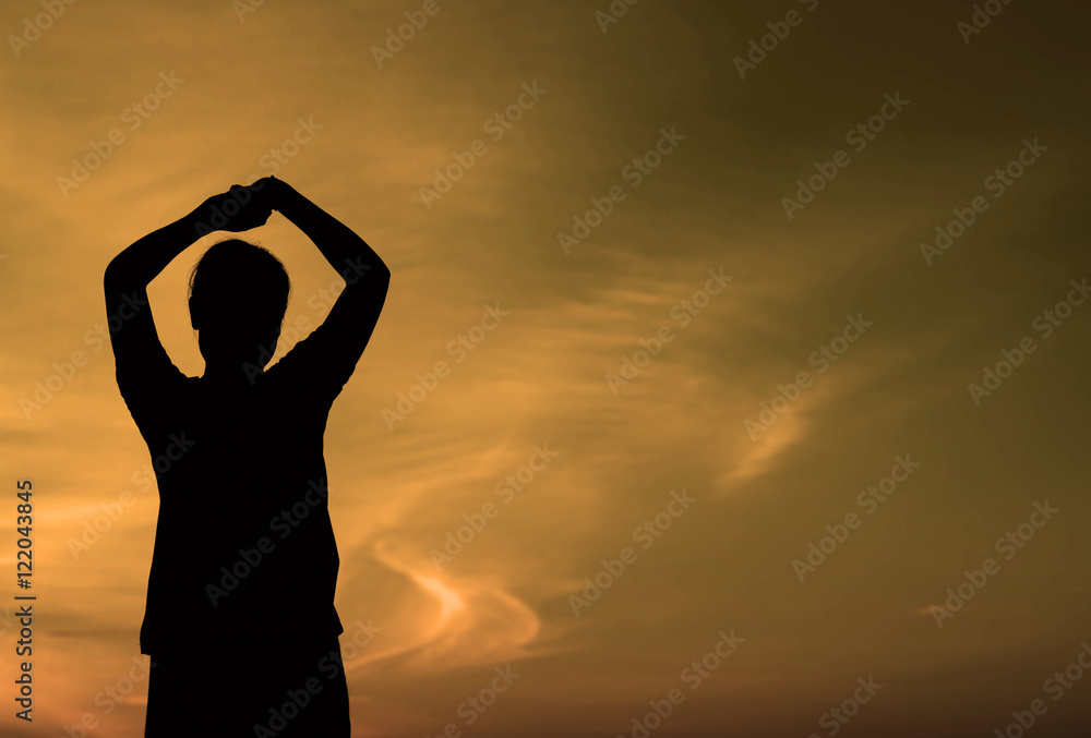Silhouette of a Woman with Hands on Head