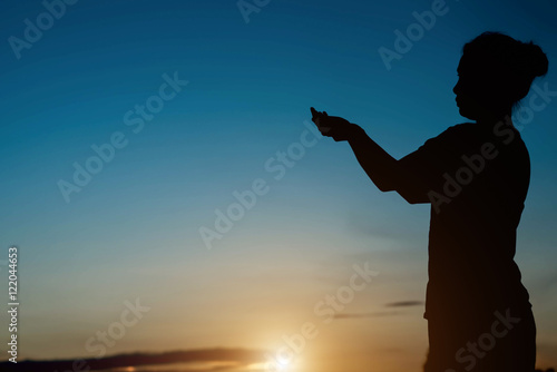 Quadro em tela Silhouette of woman which Pray to god at sunset light.