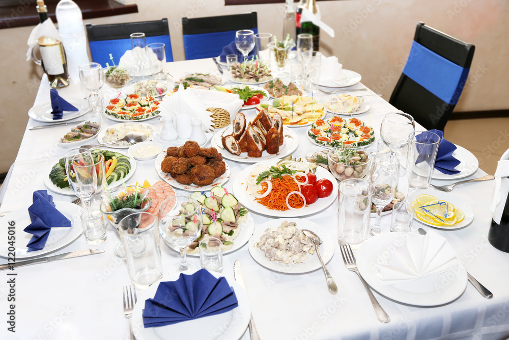 Served banquet table with dishes in restaurant Served banquet table with dishes in restaurant