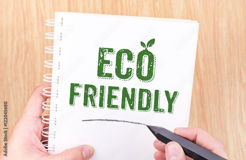 Eco friendly word on white ring binder notebook with hand holdin Eco friendly word on white ring binder notebook with hand holdin