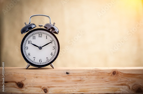 Alarm clock on a wooden plate