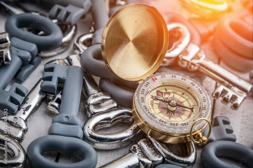 Fototapeta premium business strategy with golden compass and grey and silver keys