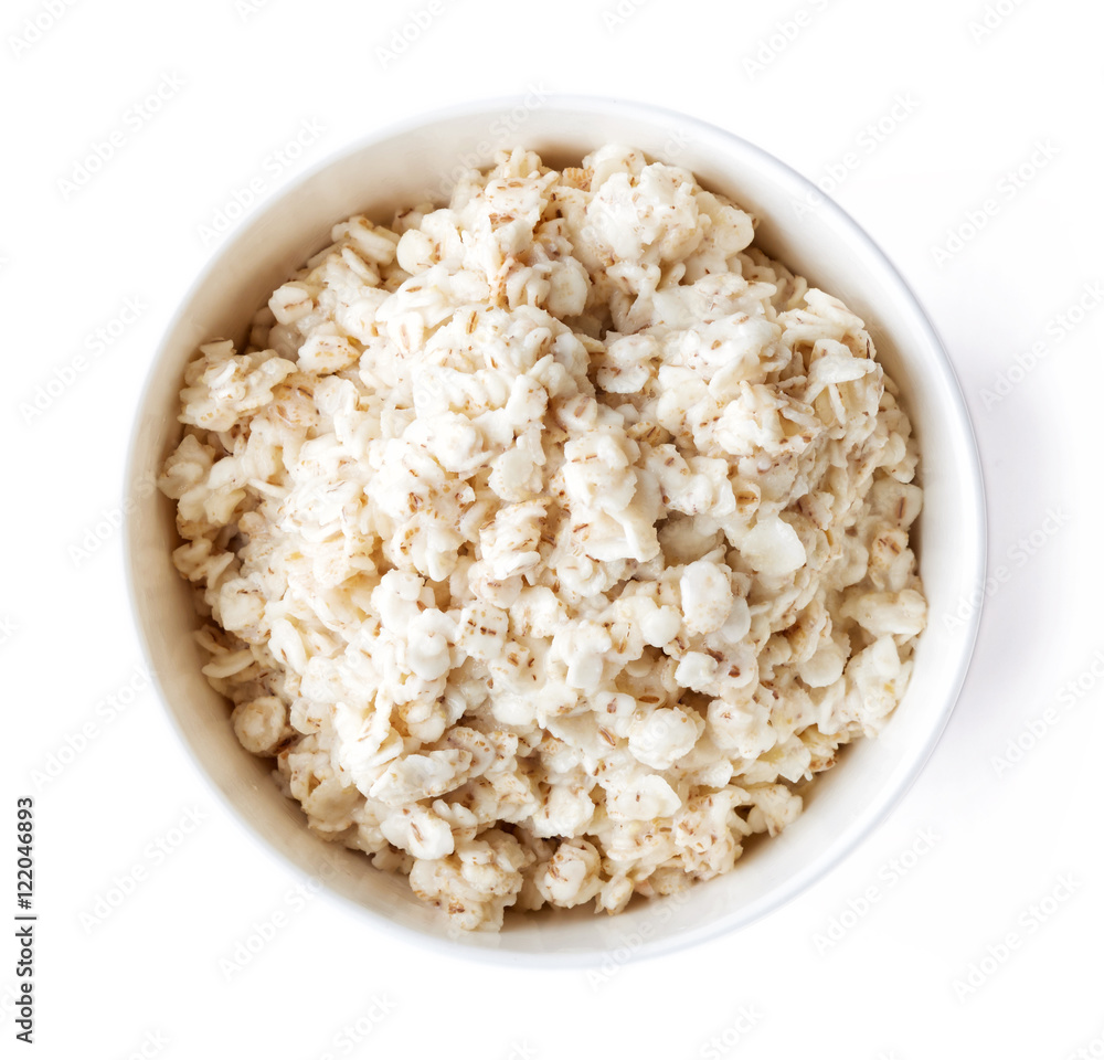 Bowl of barley porridge isolated on white, from above Bowl of barley porridge isolated on white, from above