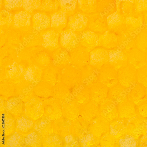 honeycomb cells under yellow honey