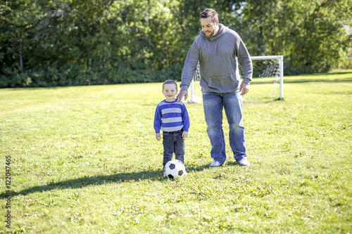 Father and Son Playing Ball in The Park